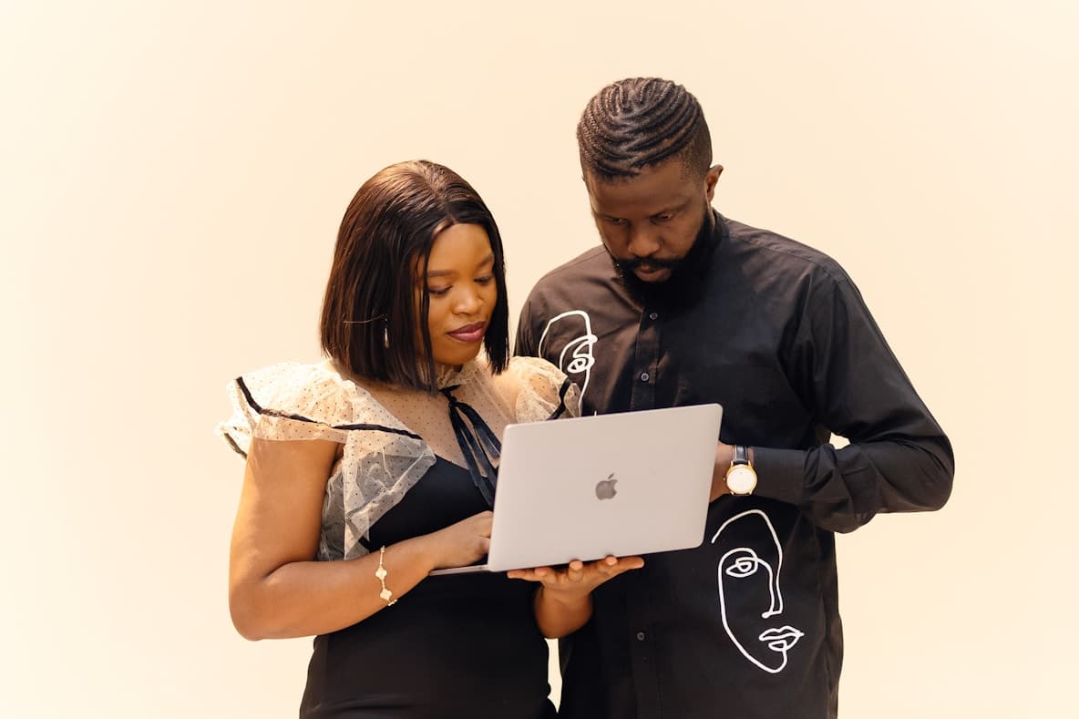 Two professionals collaborating on a laptop